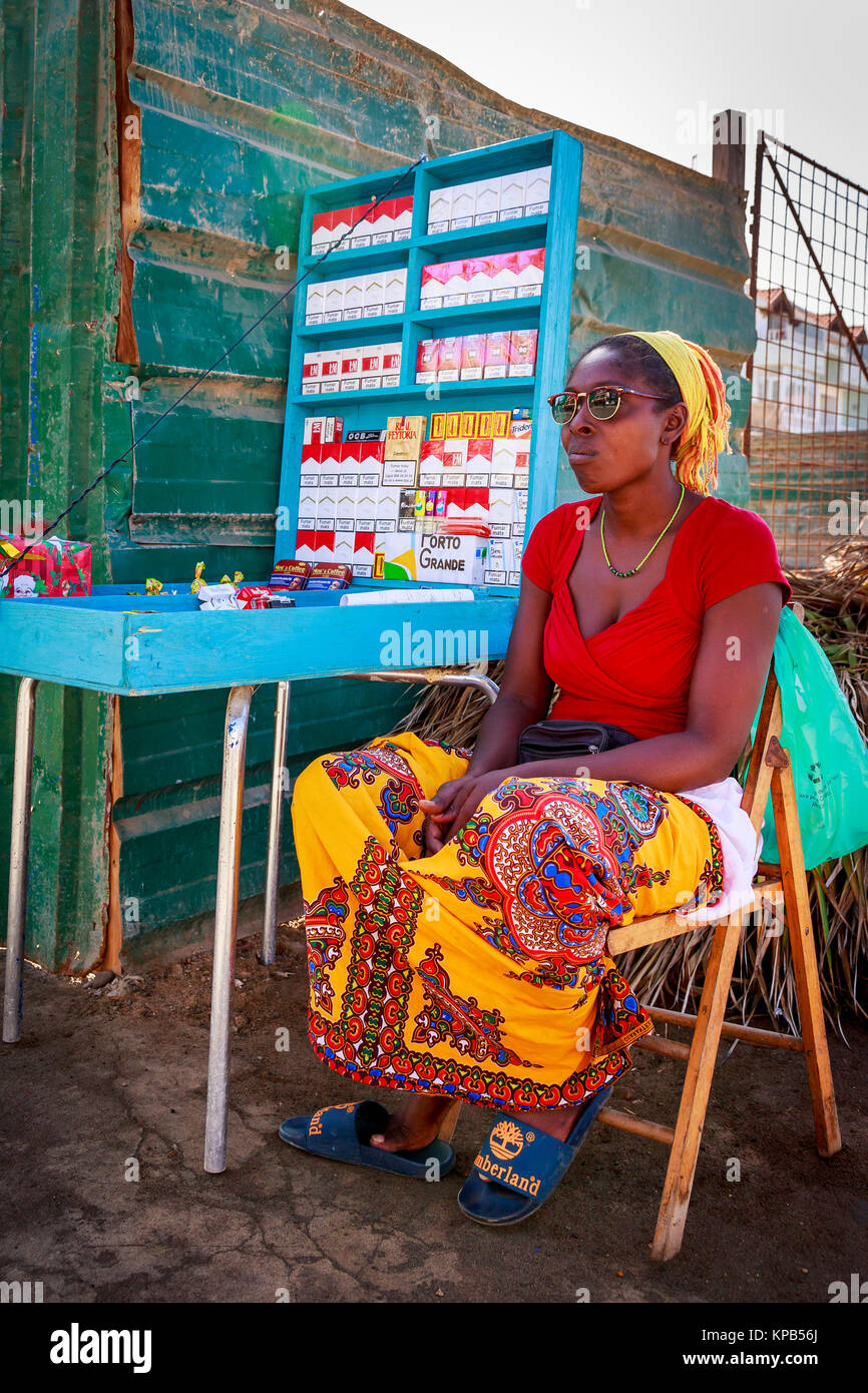 Woman selling tobacco and cigarettes at a street corner from a stall on the  pavement, Santa Maria, Sal Island, Salina, Cape Verde, Africa Stock Photo