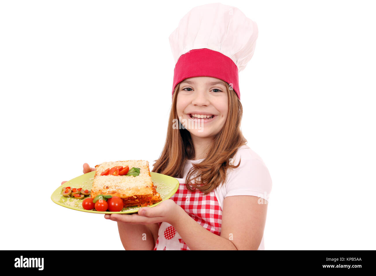 happy little cook girl with lasagne on plate Stock Photo