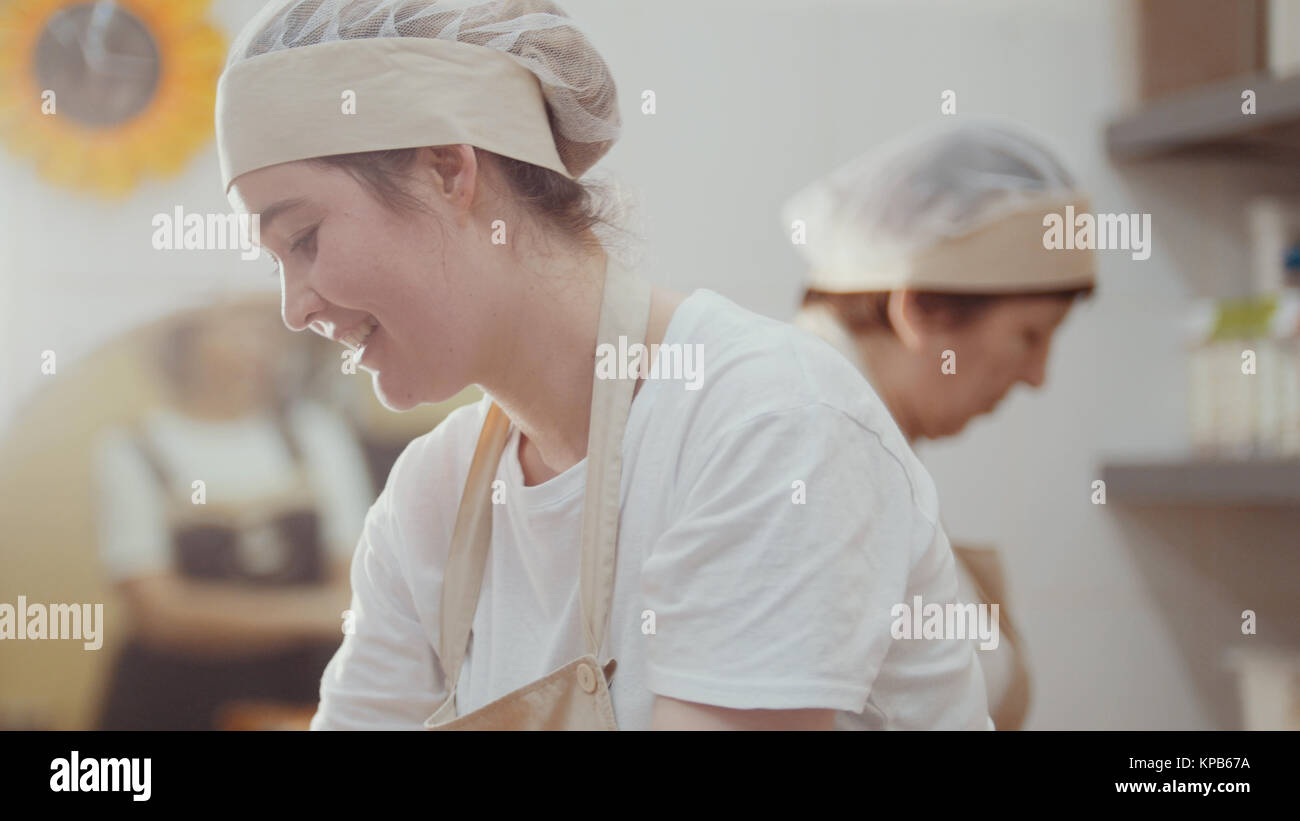 Smiling women cooks is working on the kitchen Stock Photo Alamy