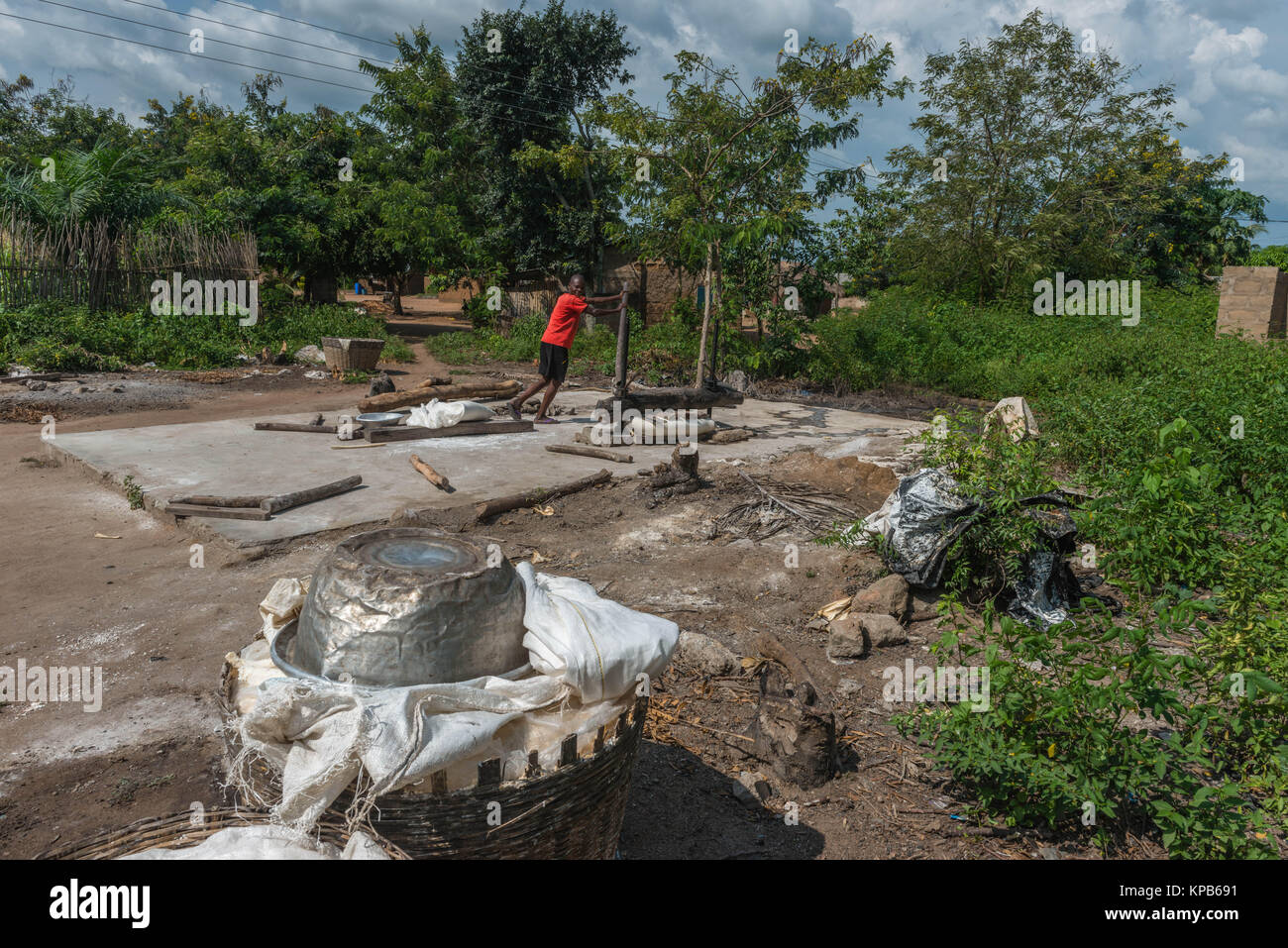 Pressing a sack of ground cassava, Village near Mafi-Kumase Proper, Volta Region, Ghana, Africa Stock Photo