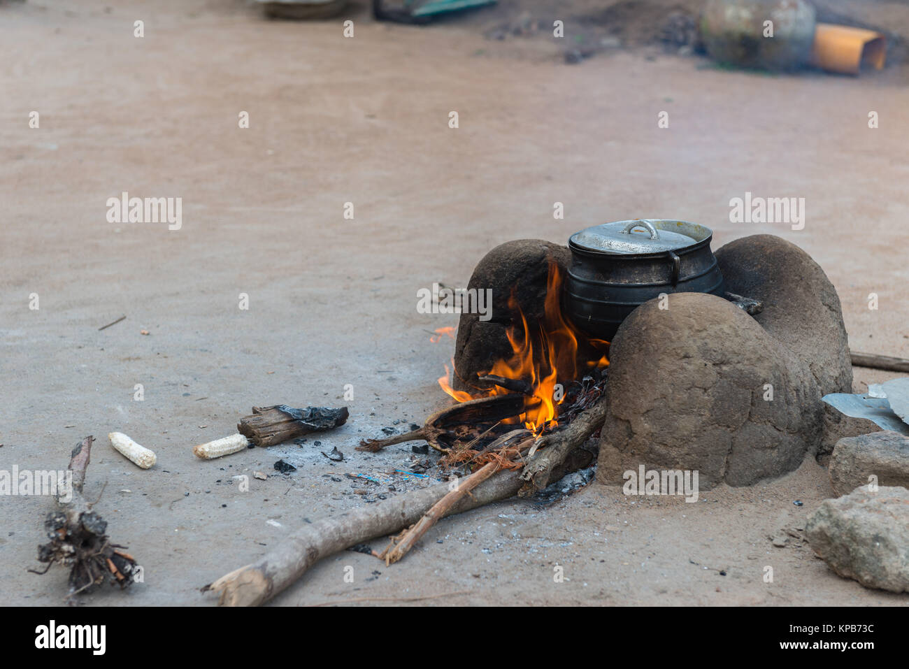 Preparing a meal on an open, non-sustainalble energy oven, village near Mafi-Kumase Proper, Volta Region, Ghana, Africa Stock Photo