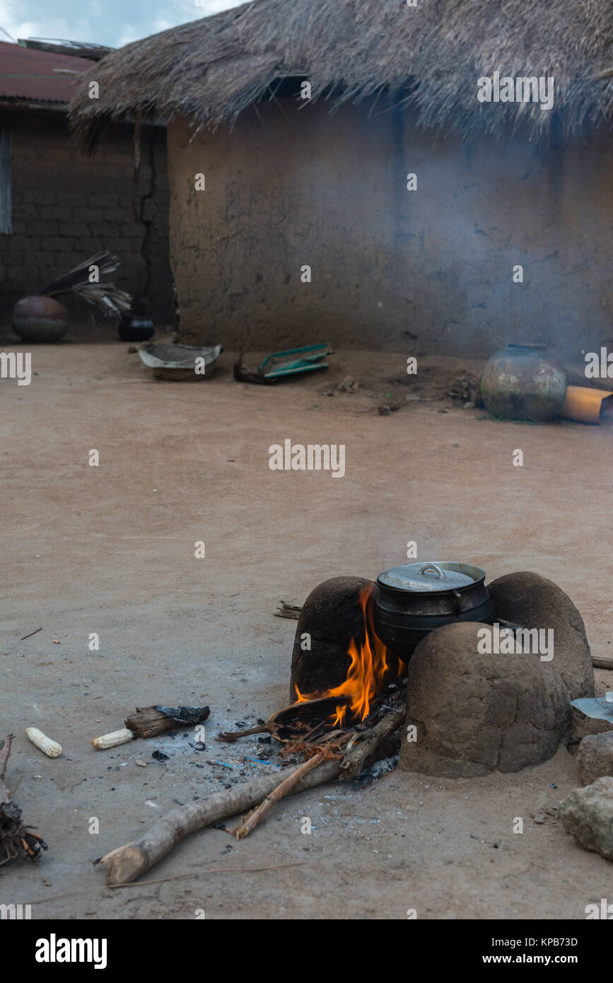 Preparing a meal on an open, non-sustainalble energy oven, village near Mafi-Kumase Proper, Volta Region, Ghana, Africa Stock Photo