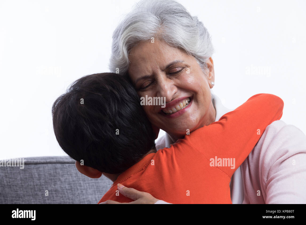 Boy hugging his grandmother Stock Photo