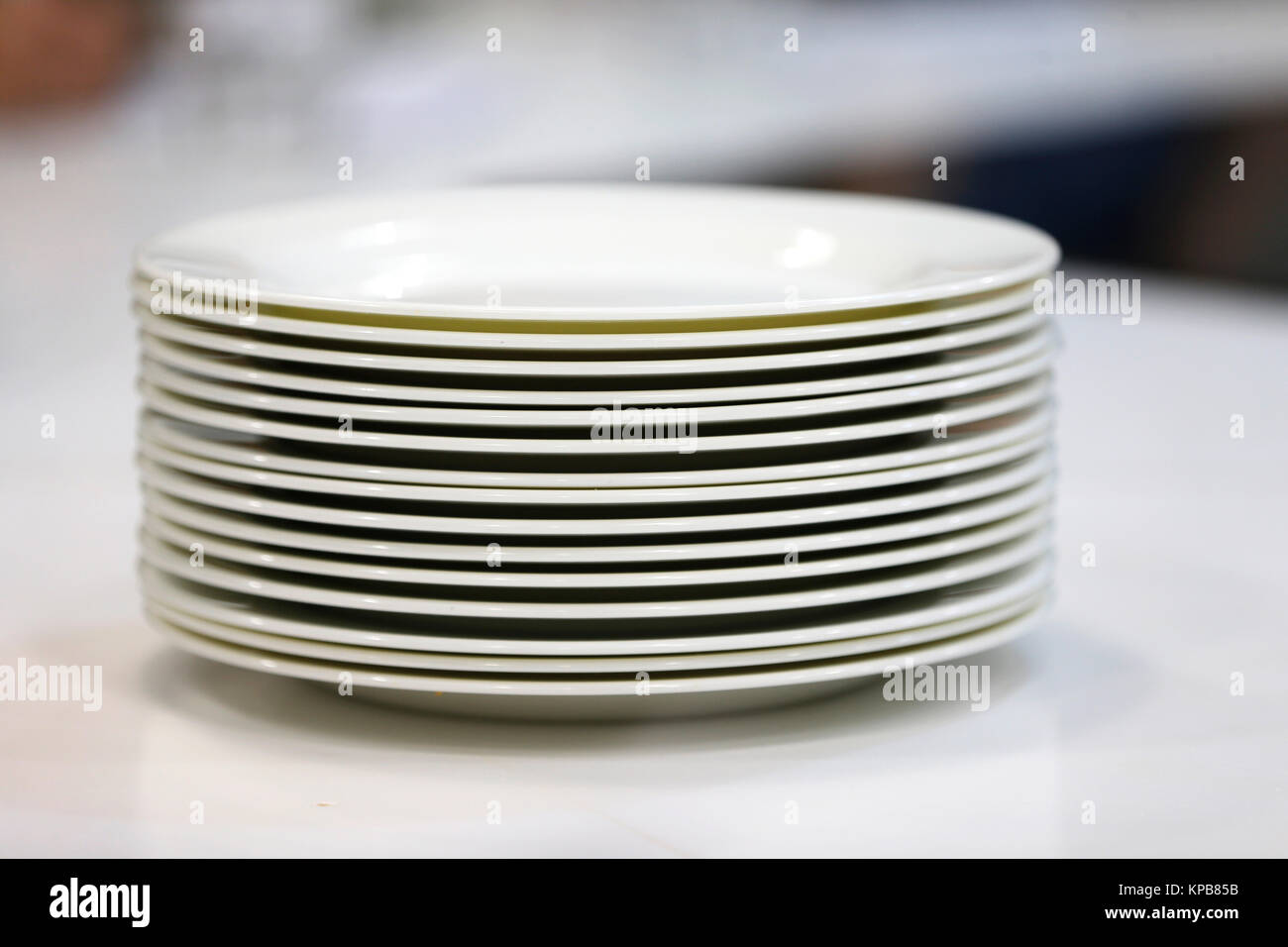 A stack of white plates.Plenty of plates. Plates from the restaurant