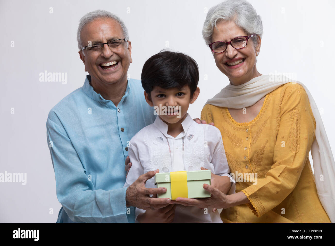 Grandparents and grandson holding gift Stock Photo