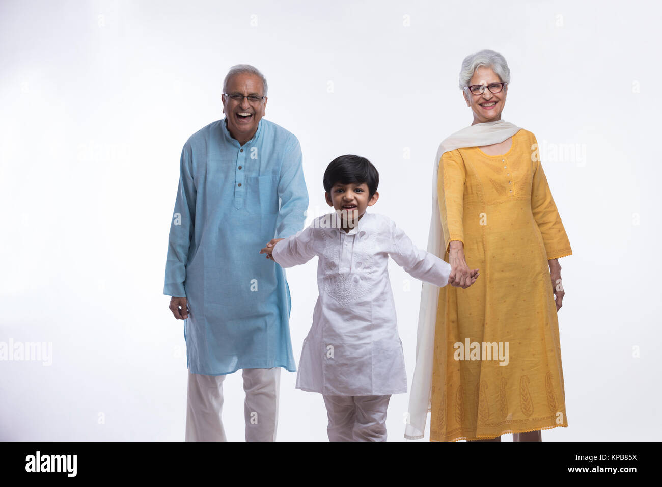 Boy holding his grandparents hands Stock Photo