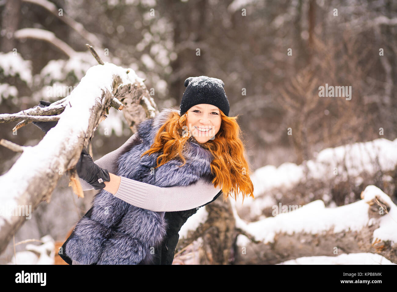 Winter beautiful girl. Portrait of pretty young girl dressed in fur coat at winter  snowy trees background. Beauty woman having fun outside in wood on Stock  Photo - Alamy