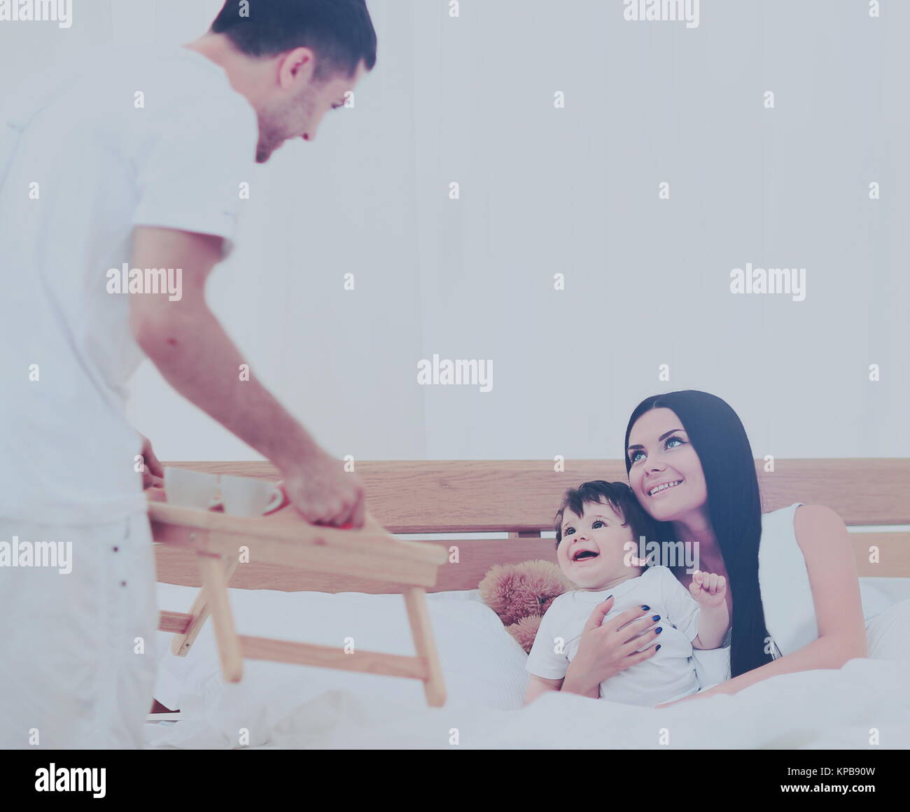 Smiling family having breakfast Stock Photo - Alamy