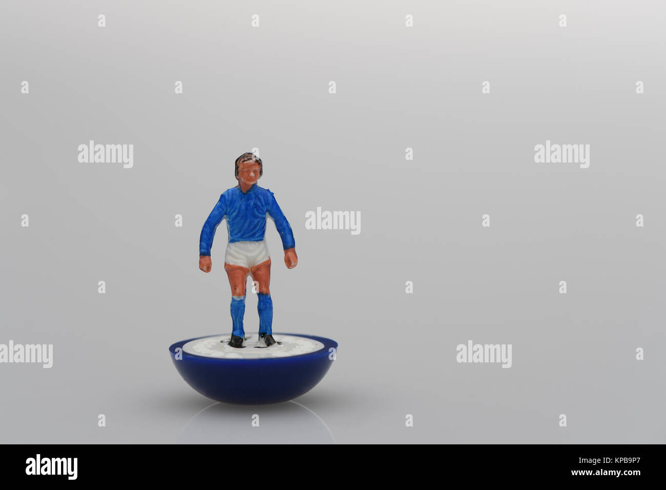 A single Subbuteo player in blue kit. Possible use as concept image. Stock Photo