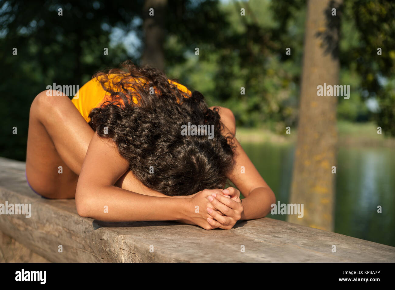 Beautiful young woman performing yoga exercises on the lake Stock Photo ...