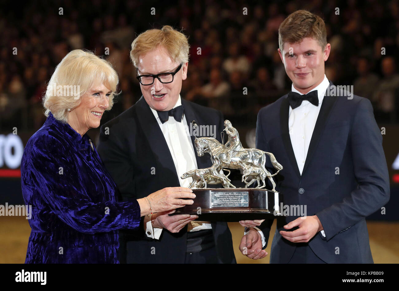 Duchess of Cornwall with Simon Brooks Ward (centre) Presents the Raymond Brooks Ward trophy to Will Furlong during day three of the London International Horse Show at London Olympia. Stock Photo