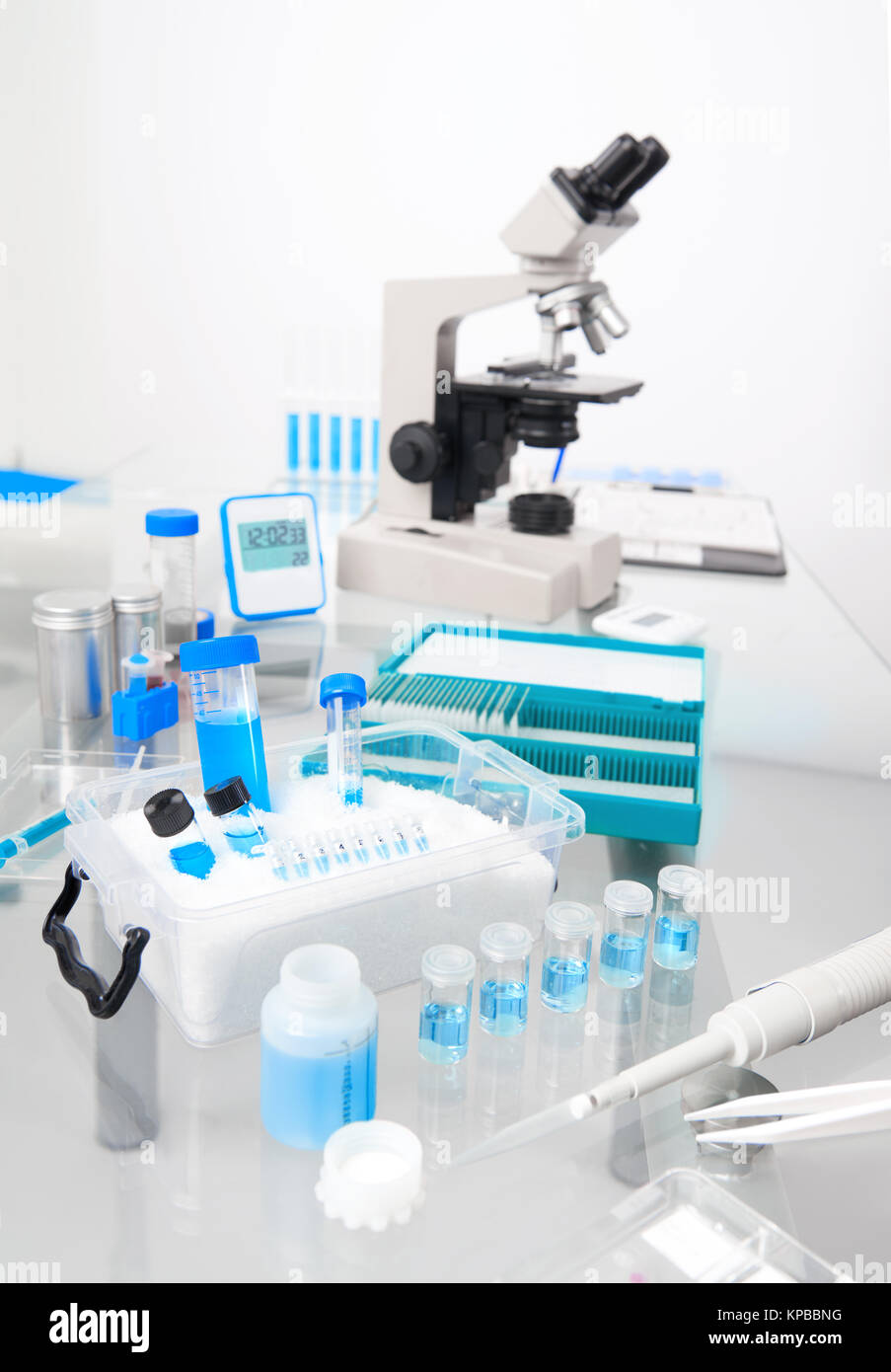 Science background with microscopic work station. Microscope and tools for histological staining for cancer diagnostics Stock Photo