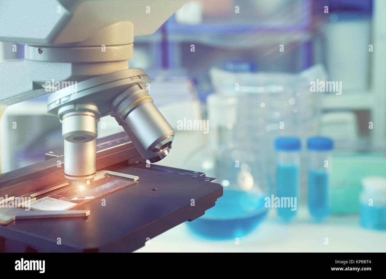 Scientific background with closeup on light microscope and laboratory ...
