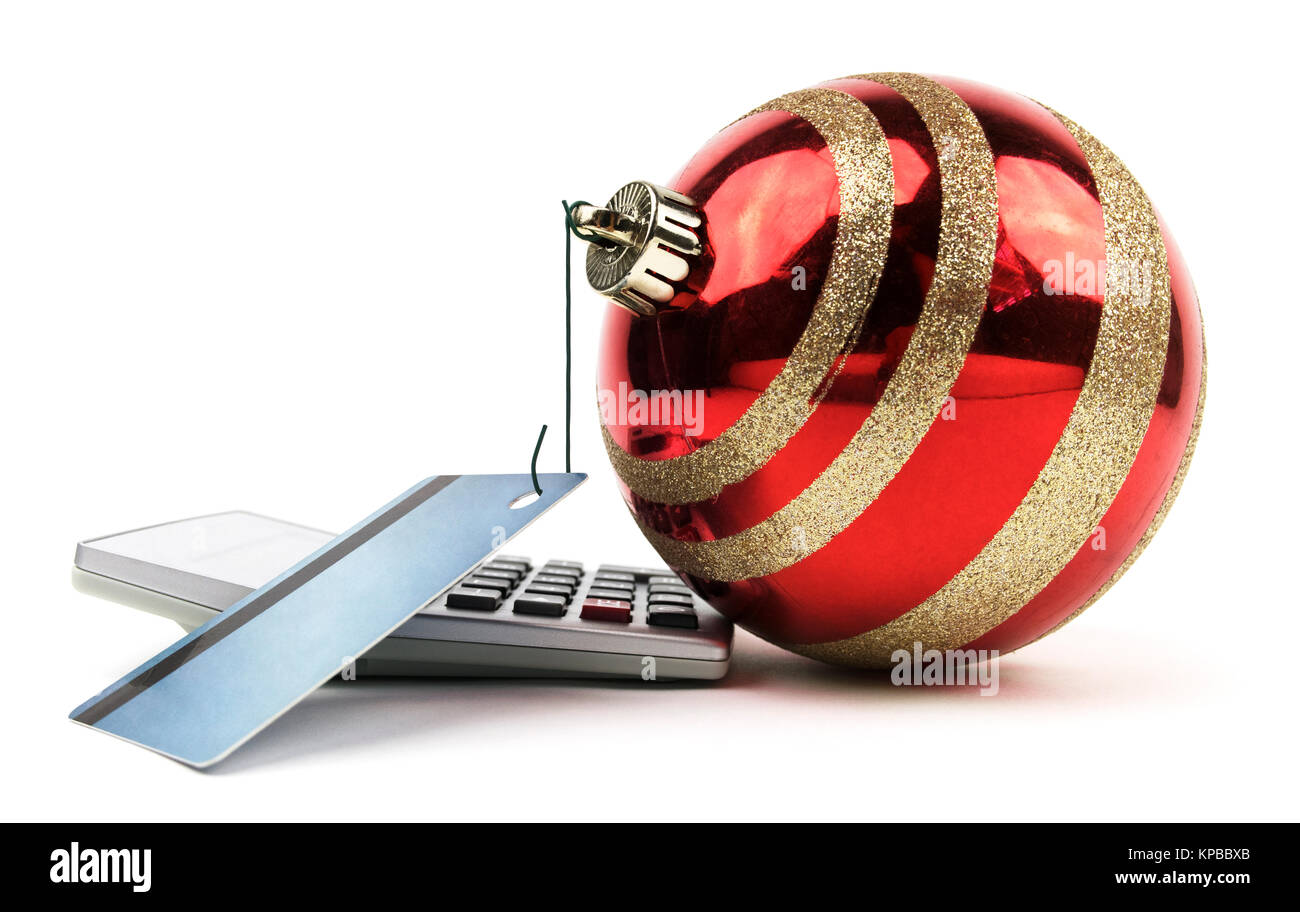 Red ornament hooked to a credit card on a calculator. Stock Photo