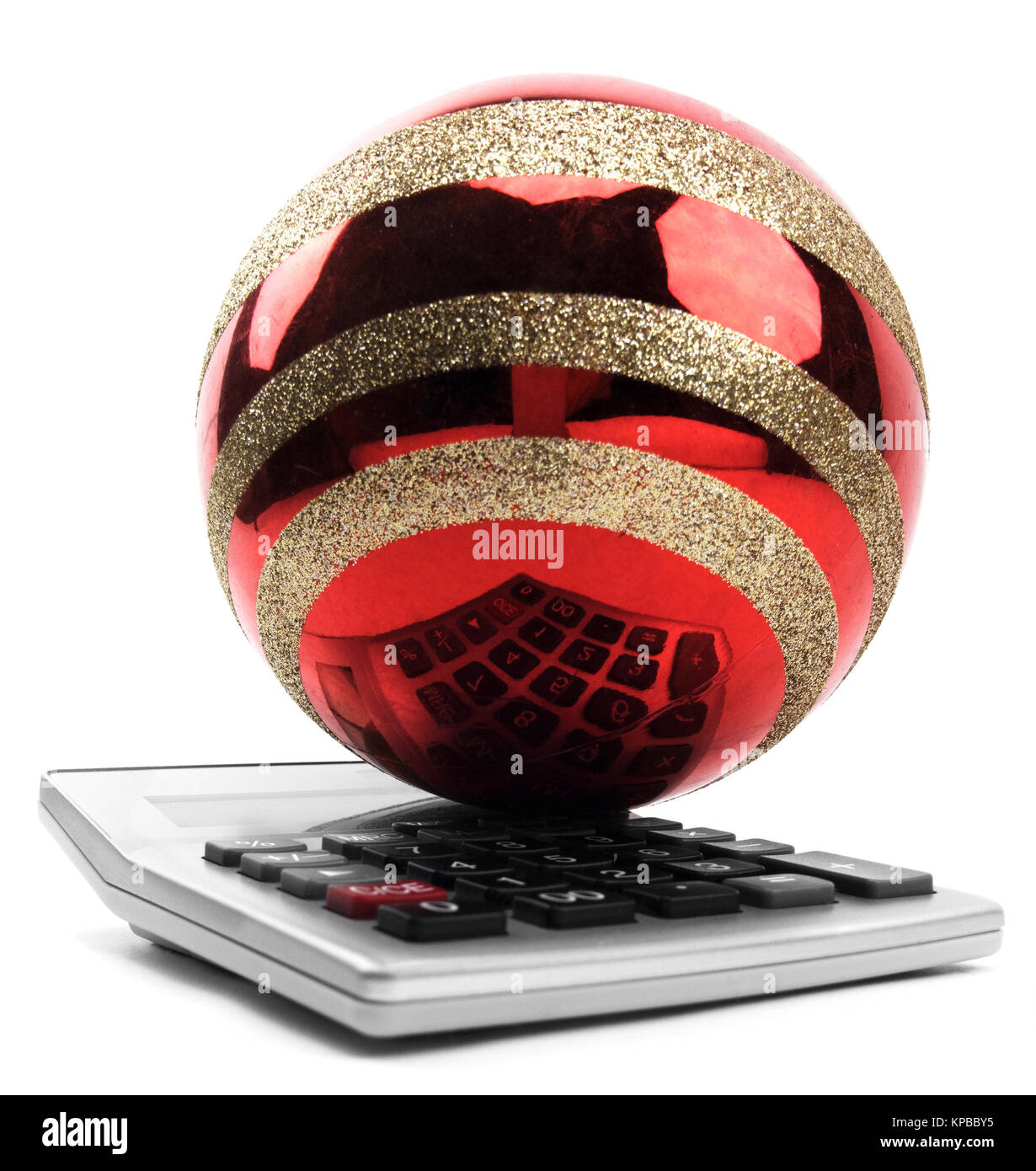 Red christmas ornament on a calculator. Stock Photo