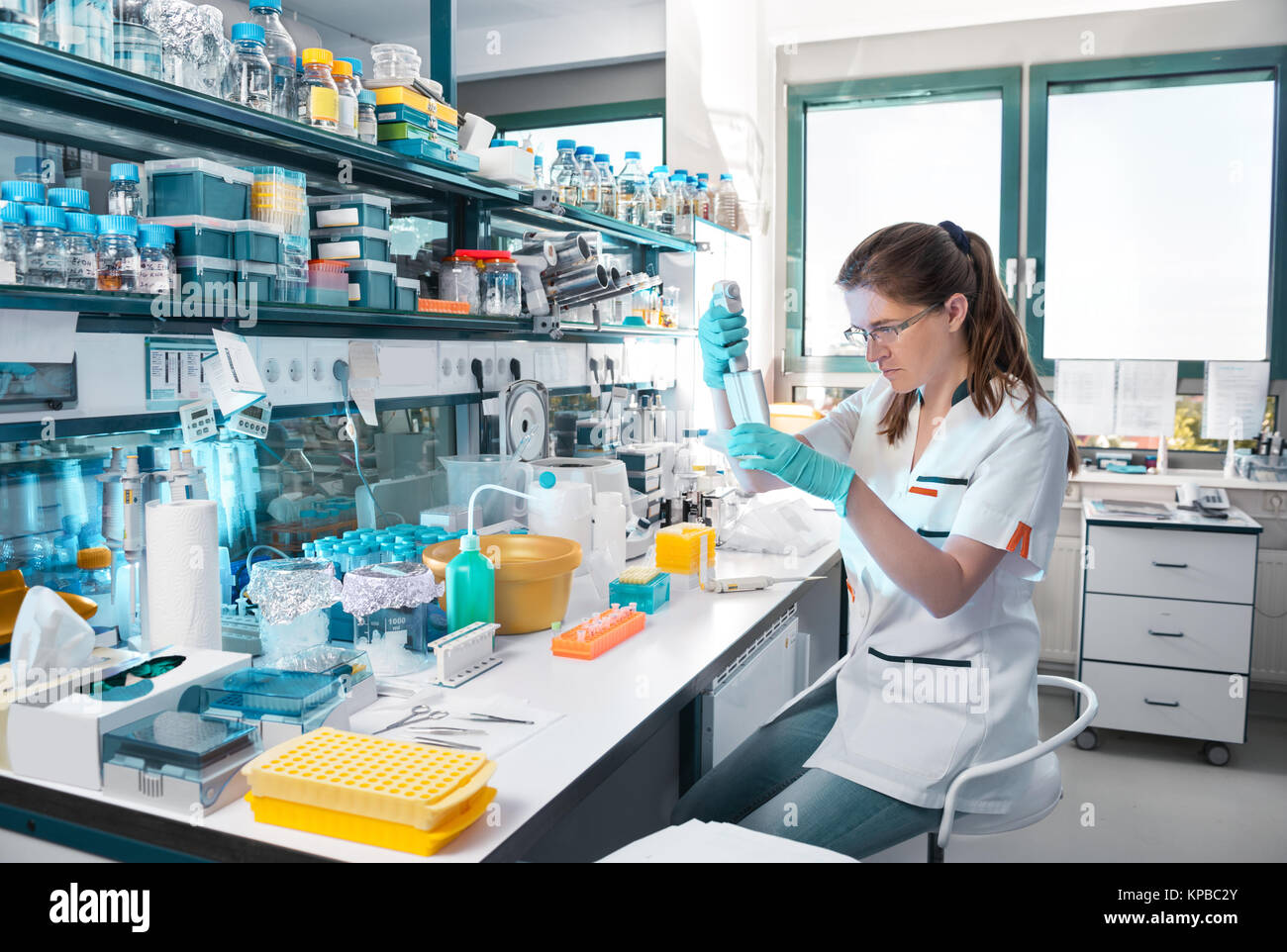 Young scientist works in modern biological lab, toned image Stock Photo