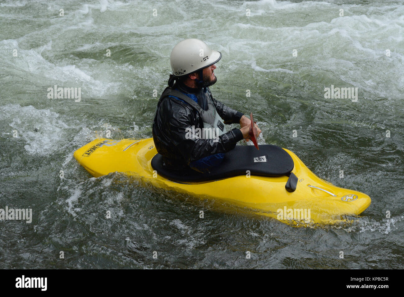 Man kayaking in river rapids at Clear Creek White Water Park in Golden Colorado Stock Photo