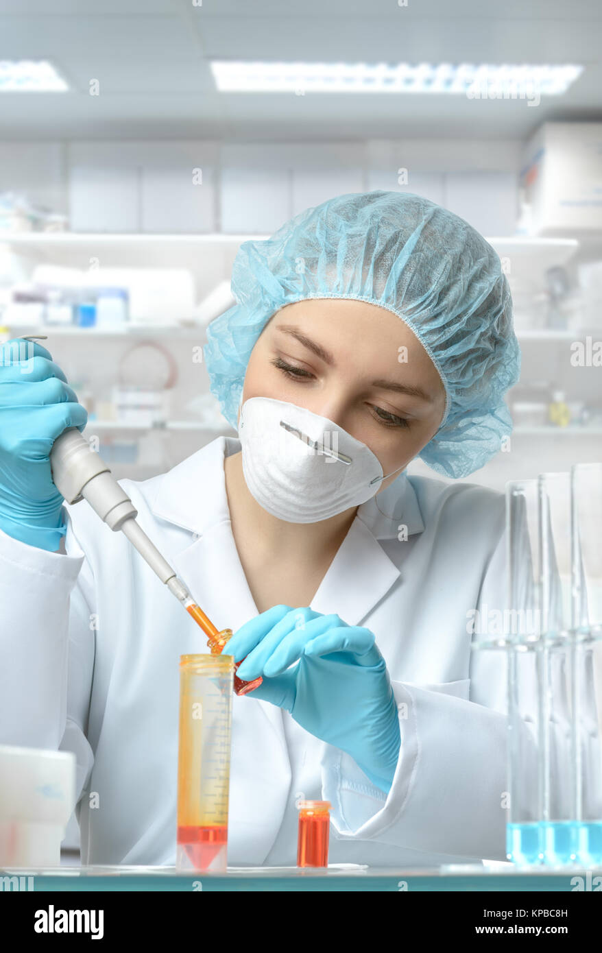 Tech Using Pipette Young female tech or scientist loads sample with automatic pipette ...