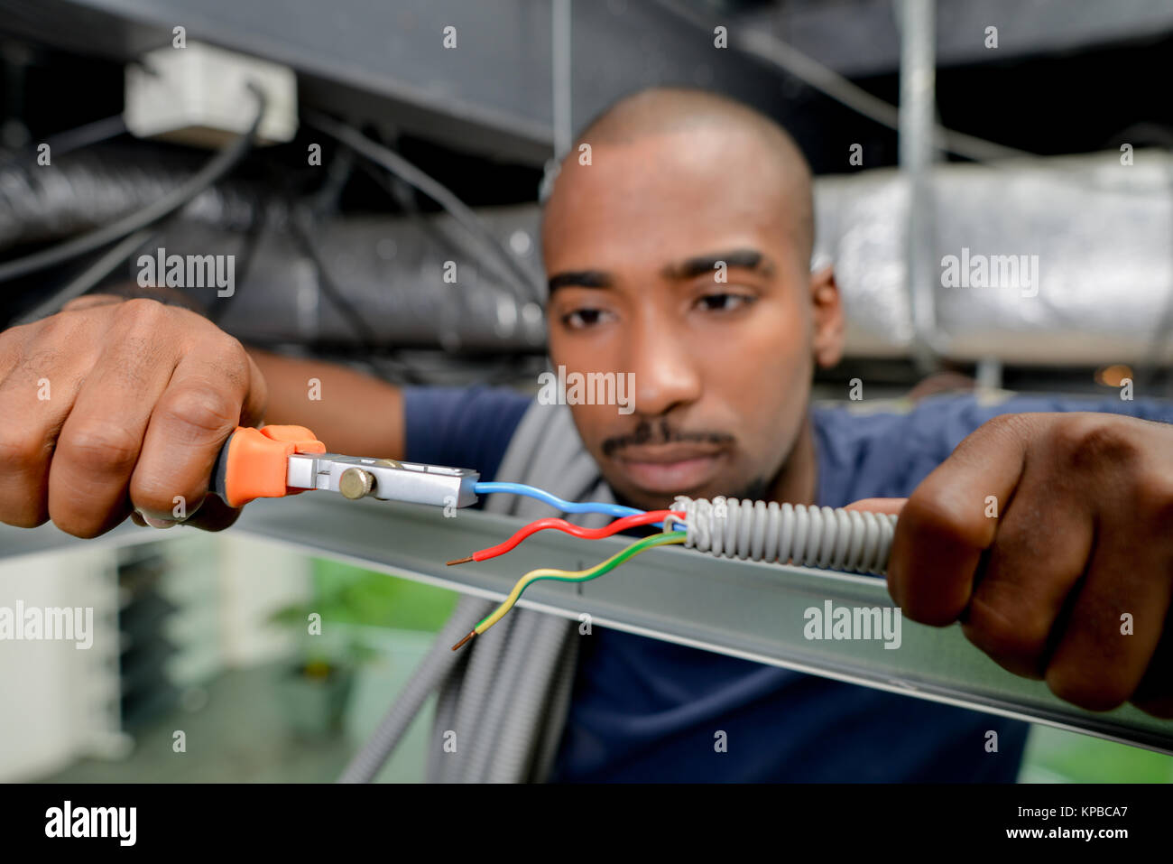 Electrician using clippers to cut wire Stock Photo Alamy