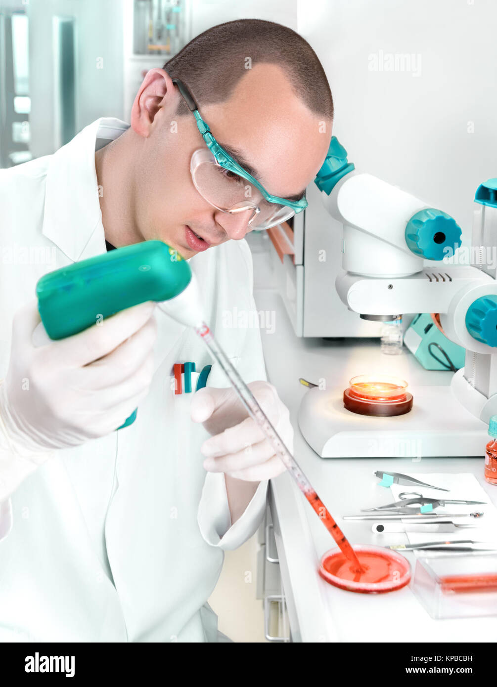 Young scientist in while lab coat works in the lab Stock Photo