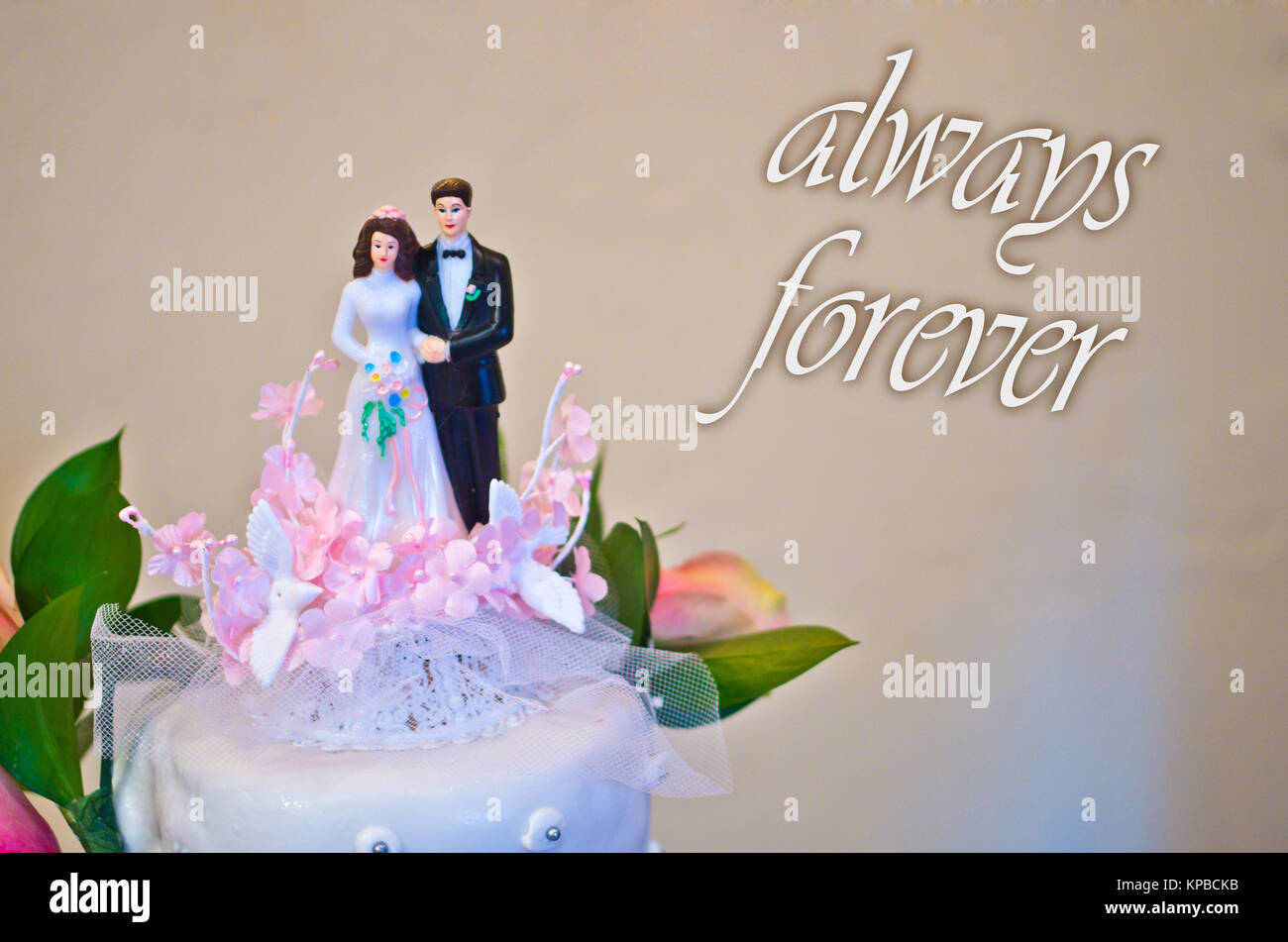 figurines of the bride and groom wedding cake wish all happiness to the newlyweds: always forever Stock Photo