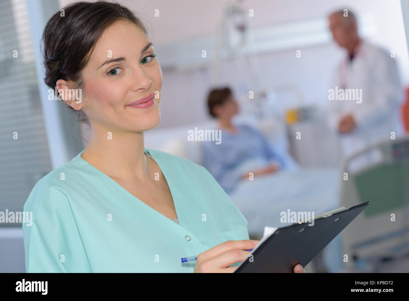 Portrait of nurse holding clipboard Stock Photo - Alamy