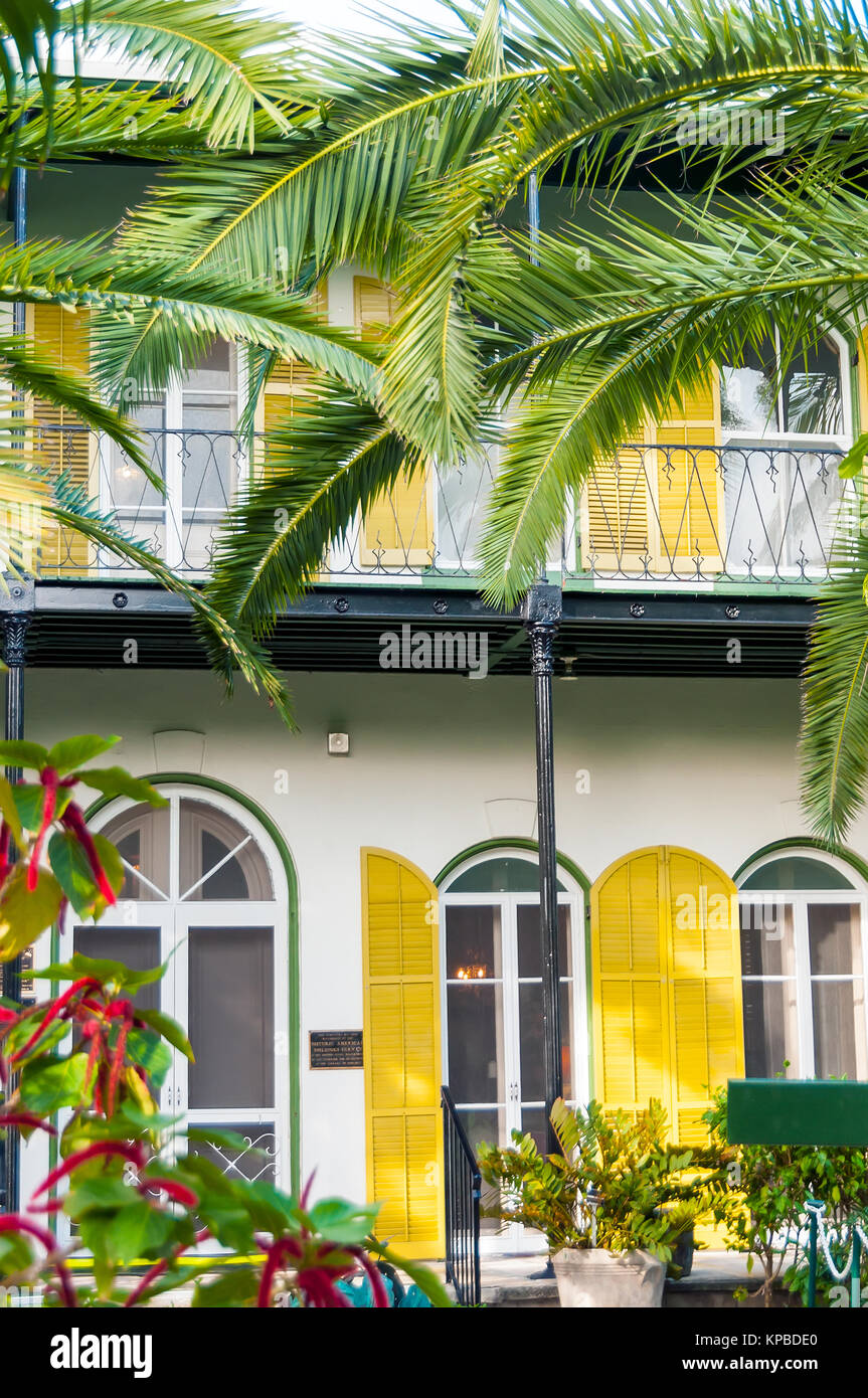 Ernest Hemingway Home & Museum yellow shutters, balcony and palm trees, Key West, Florida Stock Photo