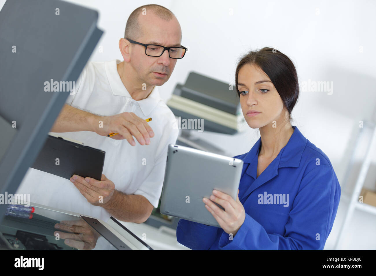 female apprentice using digital tablet Stock Photo - Alamy
