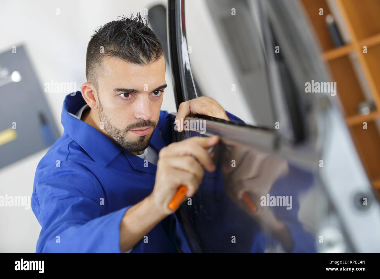 Mechanic fitting car door rubber trim Stock Photo Alamy