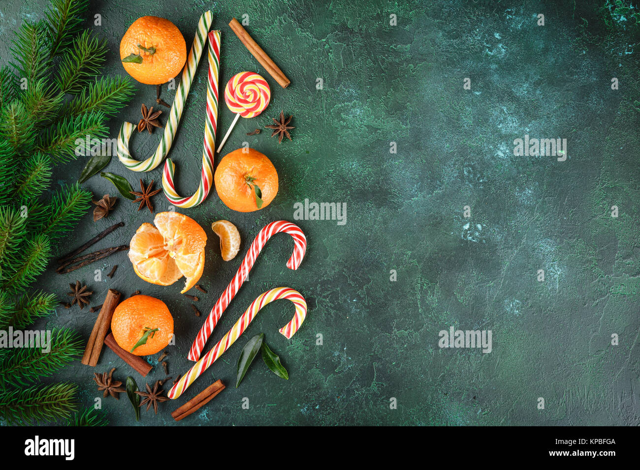 Fresh mandarins with leaves, candy canes and spices - cinnamon, anise ...
