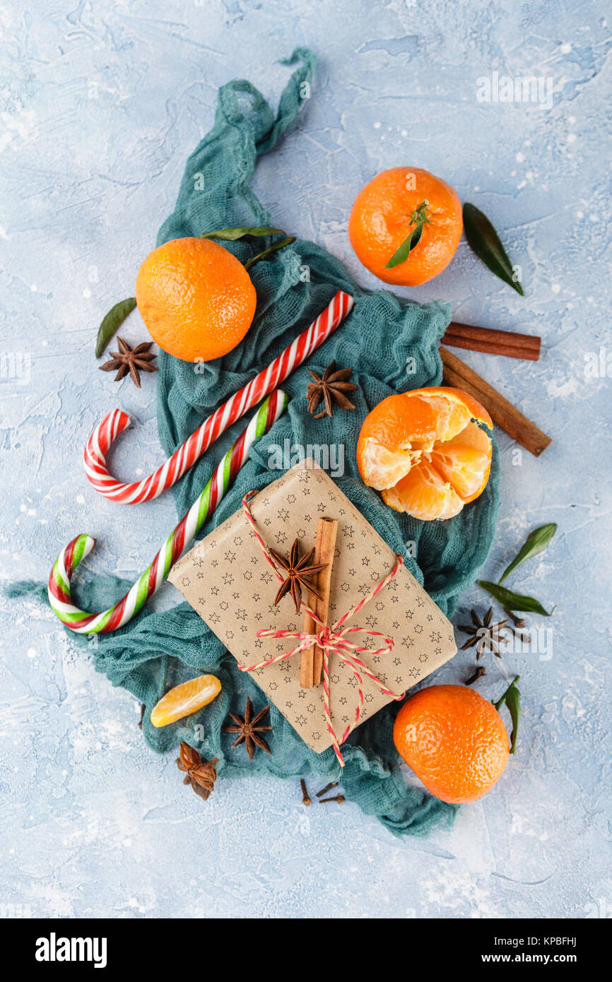 Fresh mandarins with leaves, candy canes, gift boxes in kraft paper and ...