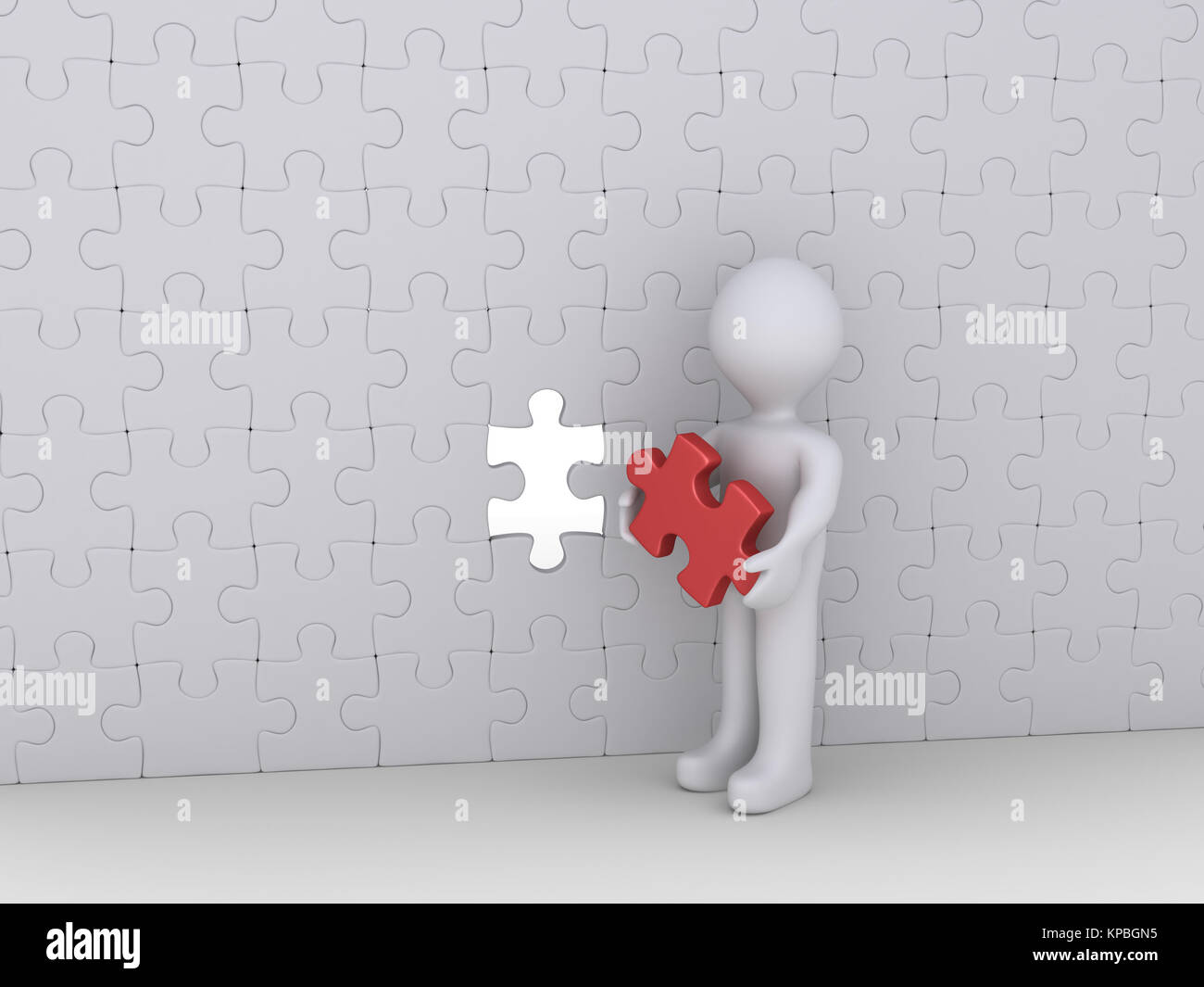 Person and last puzzle piece of wall Stock Photo
