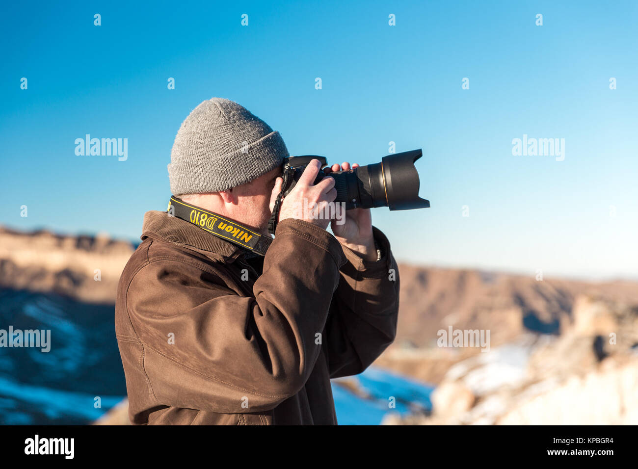 Nature photographer in winter mountains Stock Photo