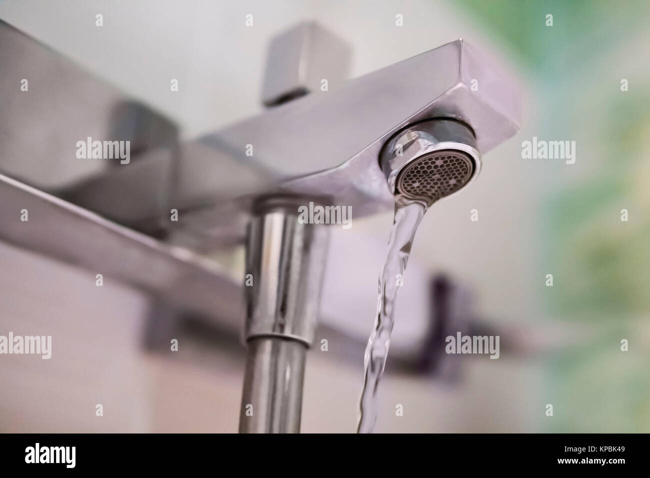 Faucet and water drop. Water flows from the tap in the bathroom. Mixer