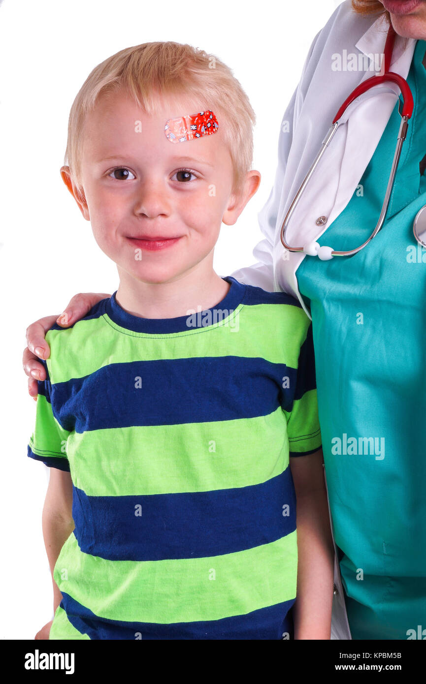 Boy has injury on forehead and gets help by the Doctor Stock Photo