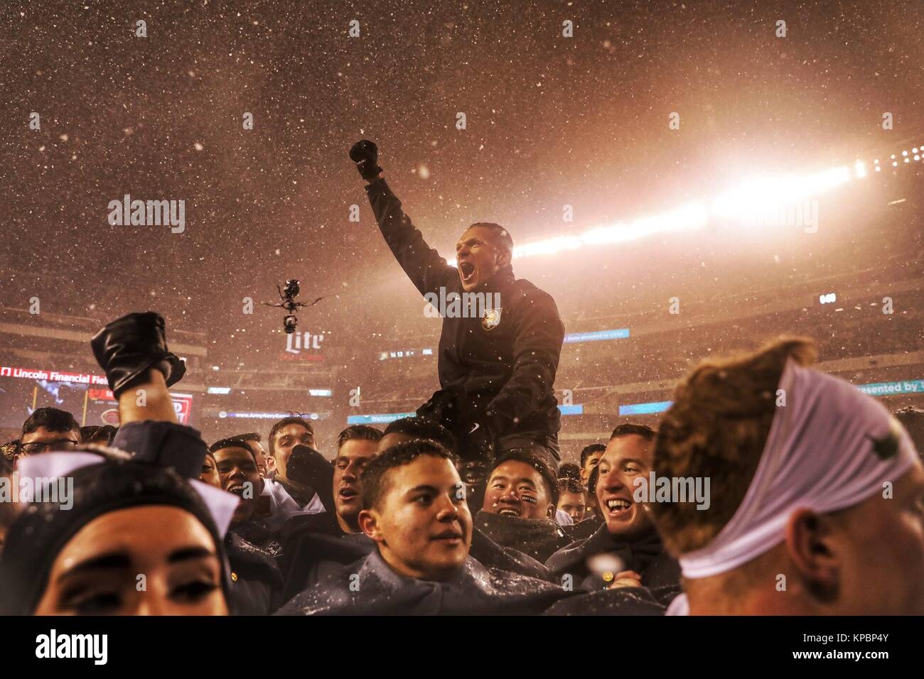 U.S. Army Black Knights football players hoist up head coach Jeff Monken after a victory during the U.S. Army Military Academy at West Point Black Knights versus U.S. Naval Academy Navy Midshipmen football game at the Lincoln Financial Field December 9, 2017 in Philadelphia, Pennsylvania. Stock Photo
