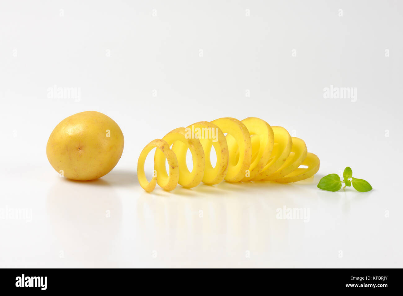 raw spiral cut potato Stock Photo Alamy