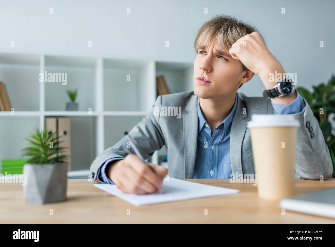 Selective focus thoughtful businessman writing hi-res stock photography ...