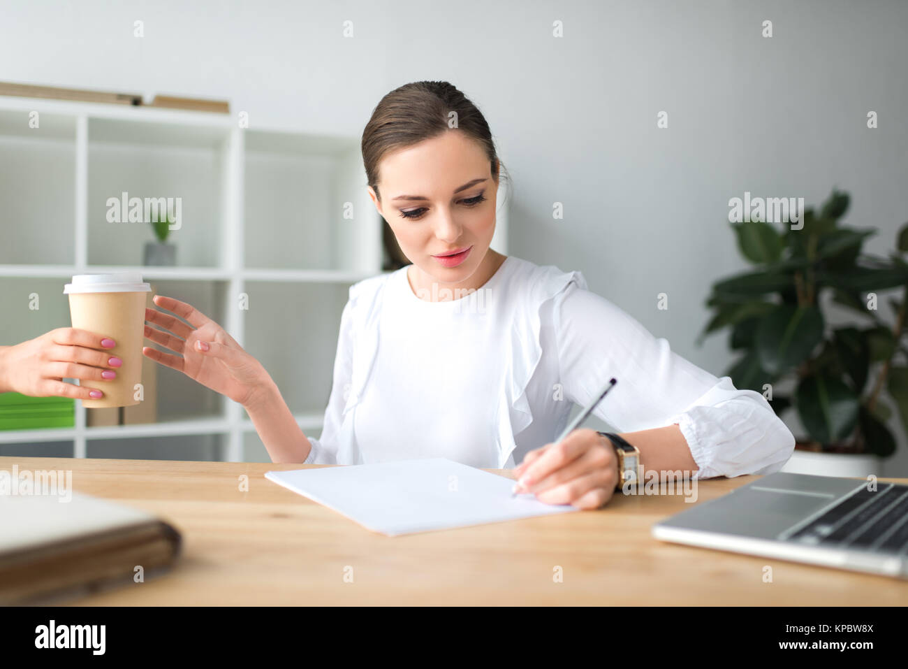 woman giving coffee in paper cup Stock Photo