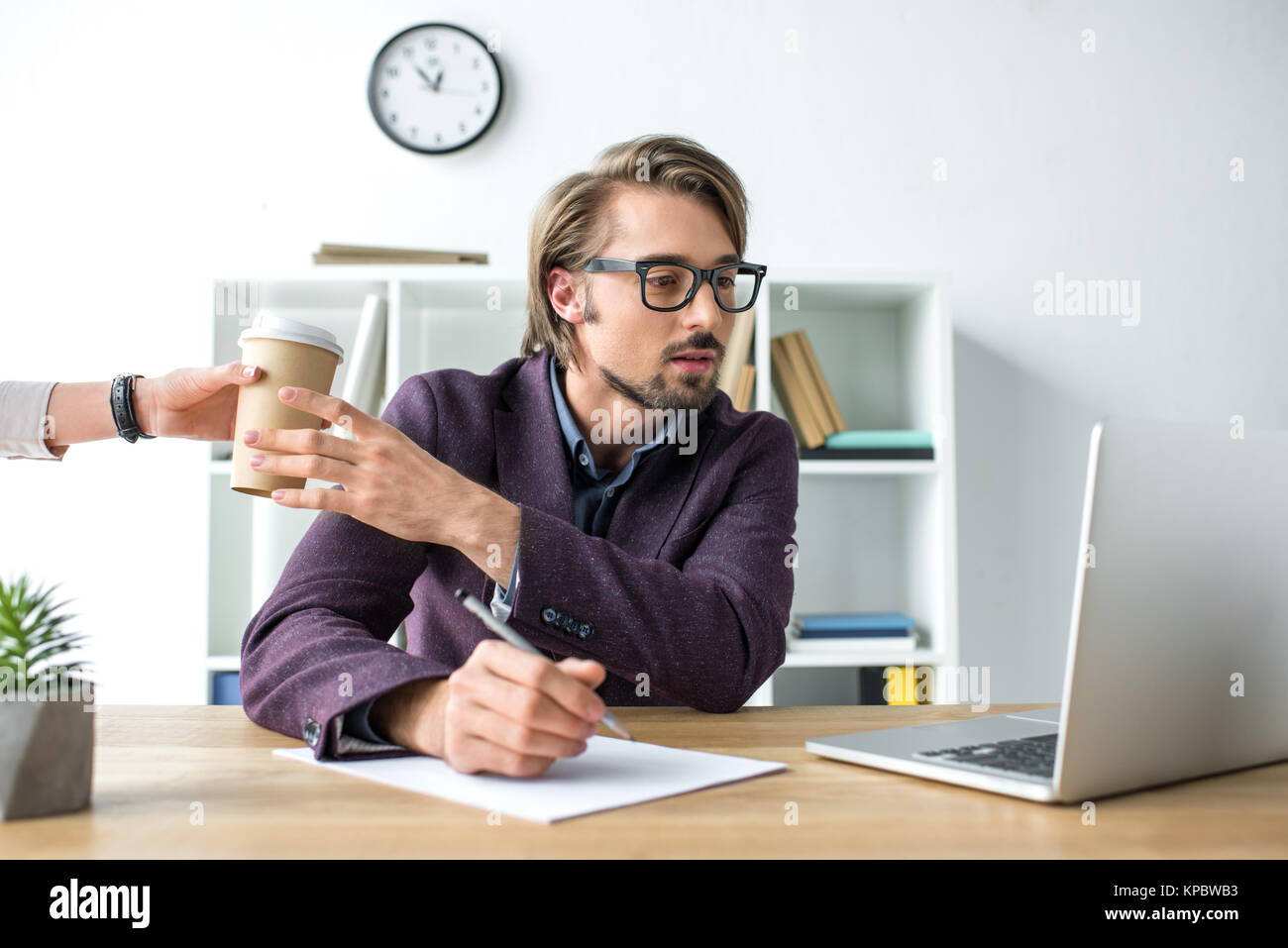 woman giving coffee in paper cup Stock Photo
