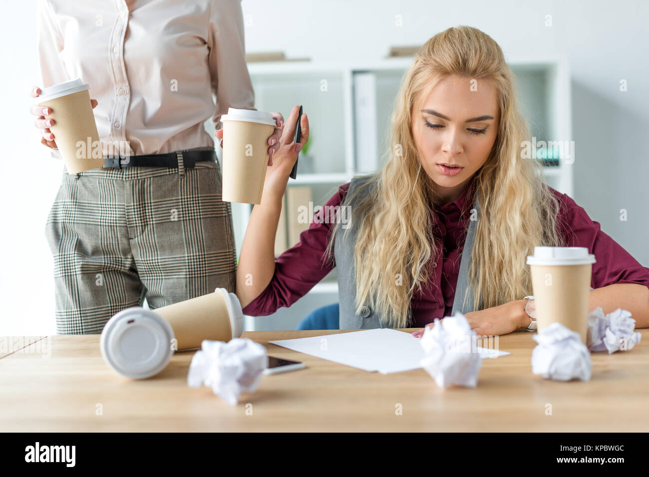 Woman bringing coffee to colleague  Stock Photo