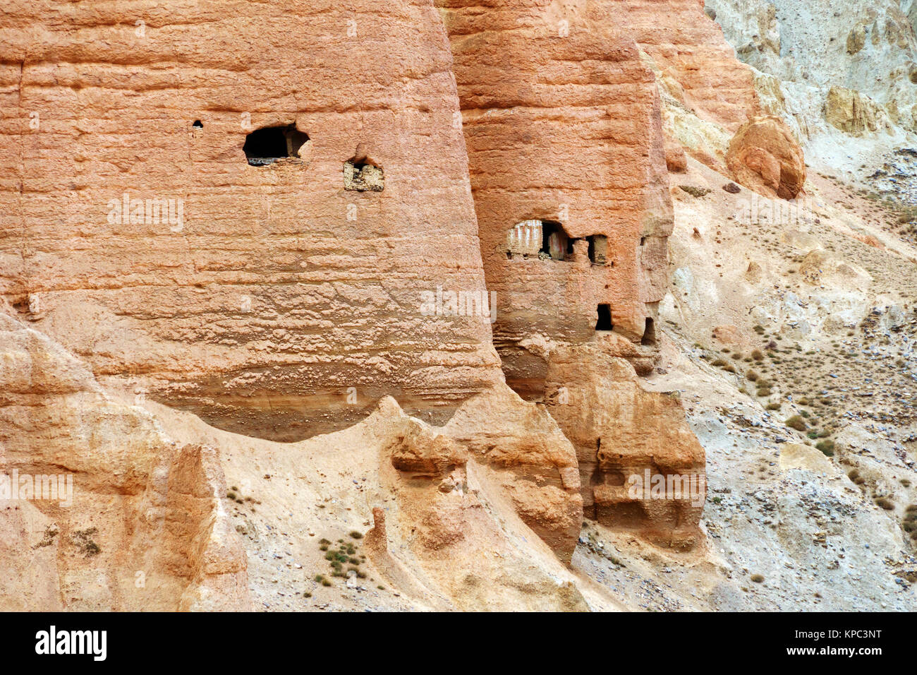 Ancient cave dwellings carved in cliffs near Dhakmar, Upper Mustang region, Nepal. Stock Photo