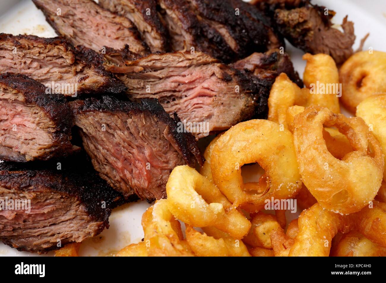 Flank steak with fries onion rings Stock Photo Alamy