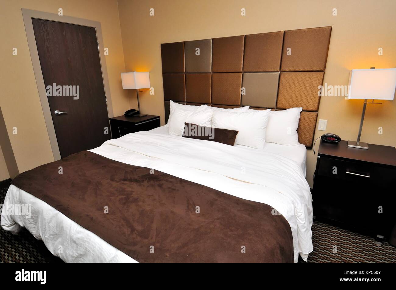 Large queen sized bed with romantic lighting Stock Photo Alamy