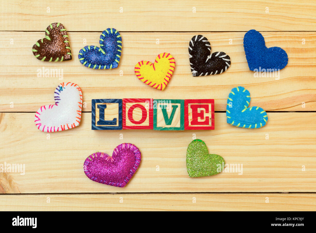 Romantic hearts on a wood table and words with wood cubes stock photo