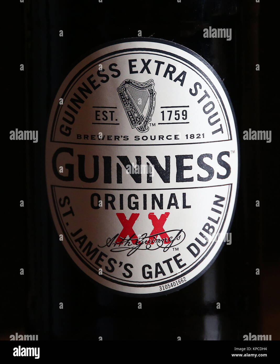 a-bottle-of-guiness-original-extra-stout-on-a-table-in-a-pub-stock