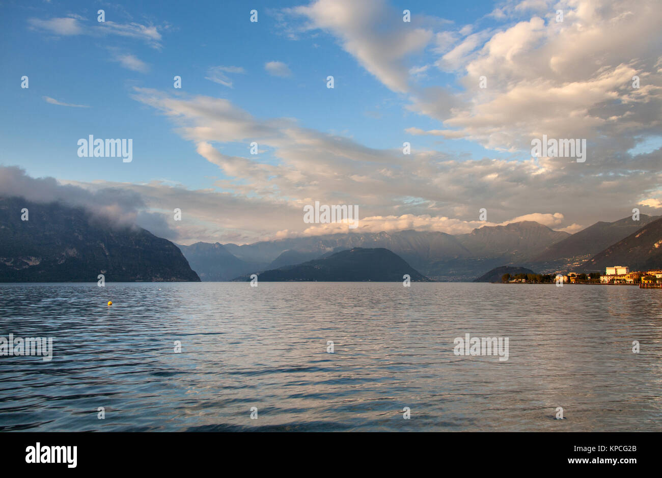 Lake Iseo, Italy. Picturesque dusk view of Lake Iseo, with the town of Iseo on the right of the image and the island (and town ) of Monte Isola is in  Stock Photo