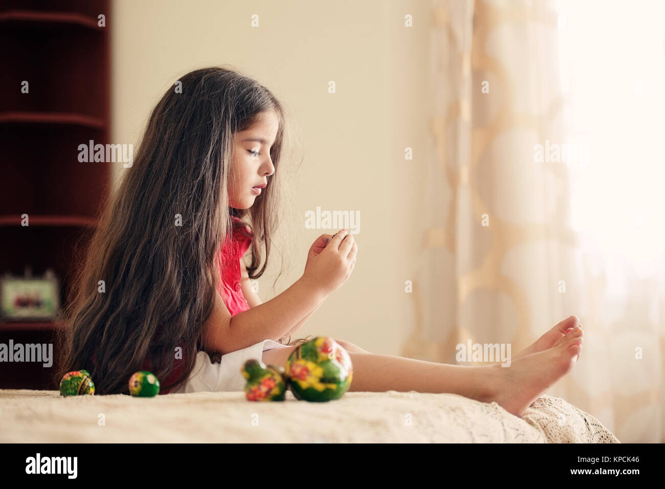 Girl playing with matryoshka dolls Stock Photo