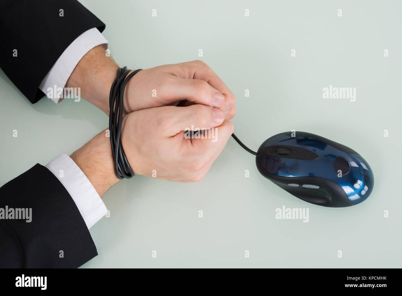Person Wrist Tied With Computer Mouse Cable Stock Photo - Alamy
