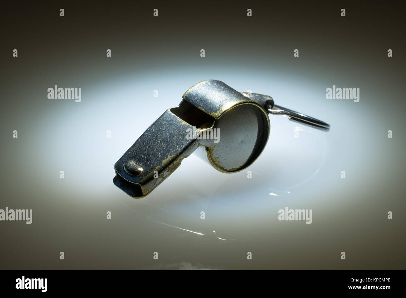 Worn and marked sports whistle made of plated brass. Used by referees, coaches and other officials. Stock Photo